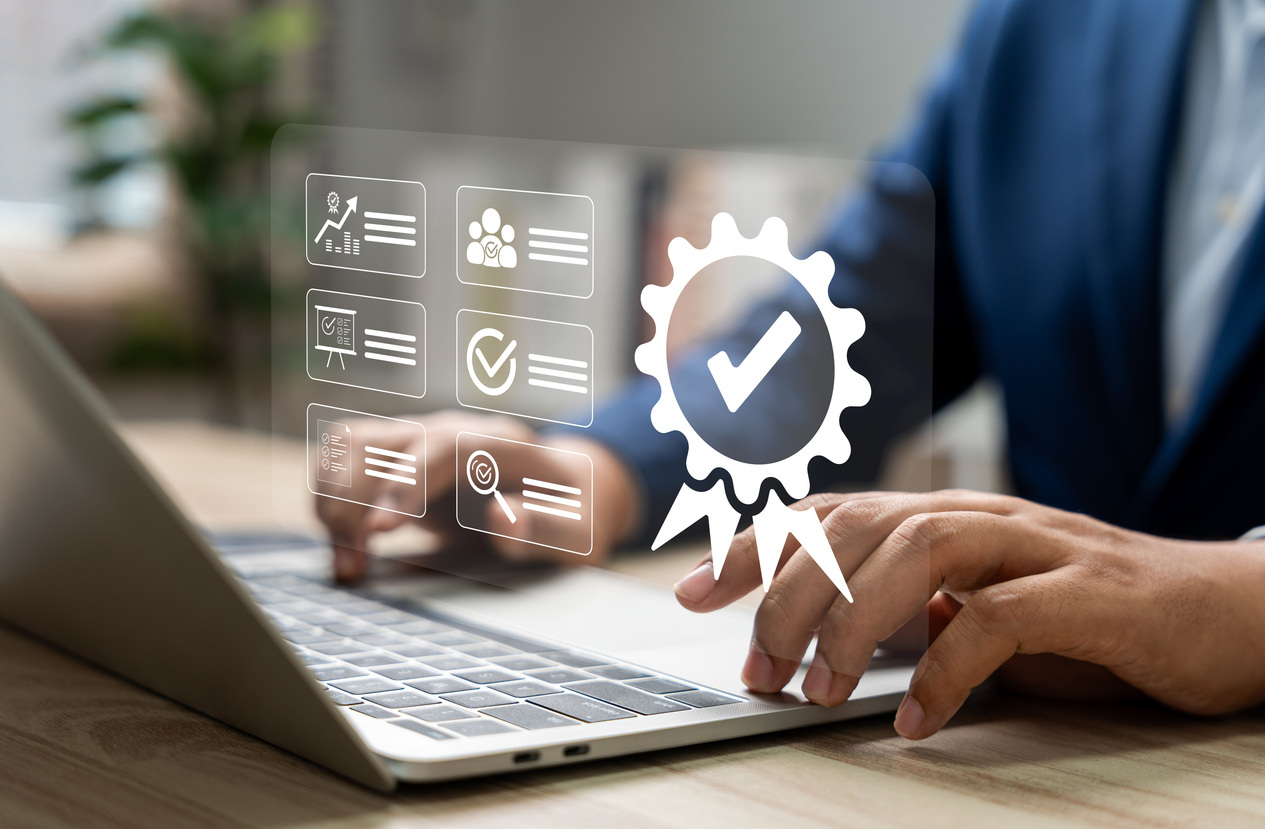 ISO certification and quality assurance, Businessman working with computer and tablet, Symbolizing compliance, Standards, Top service for product quality management. Businesses and companies.